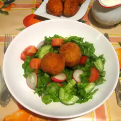 Breaded Eggs on a Salad with Garlic Sauce